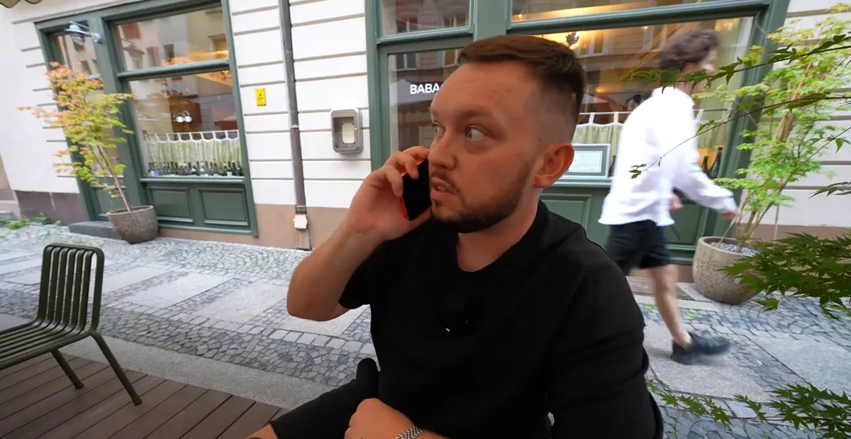 Książulo rozmawia przez telefon z szefową restauracji Baba przed lokalem przy Nożowniczej